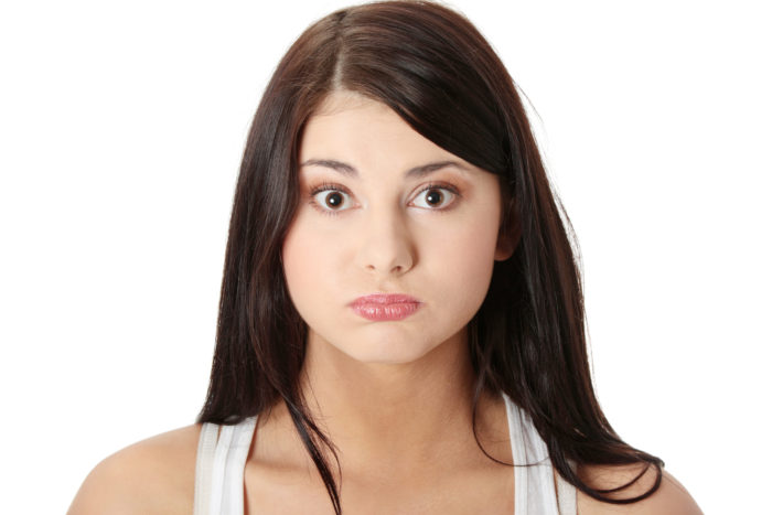 Young woman with hiccup, isolated on white