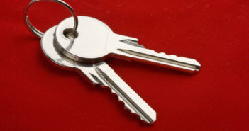 two keys on a ring over red background