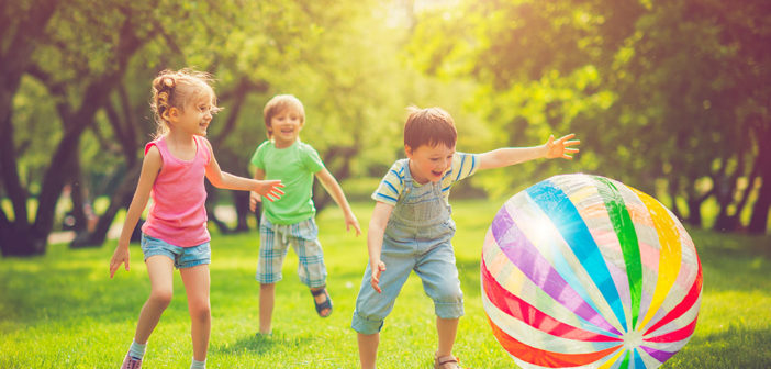 little_girl_and_boys_playing_with_ball